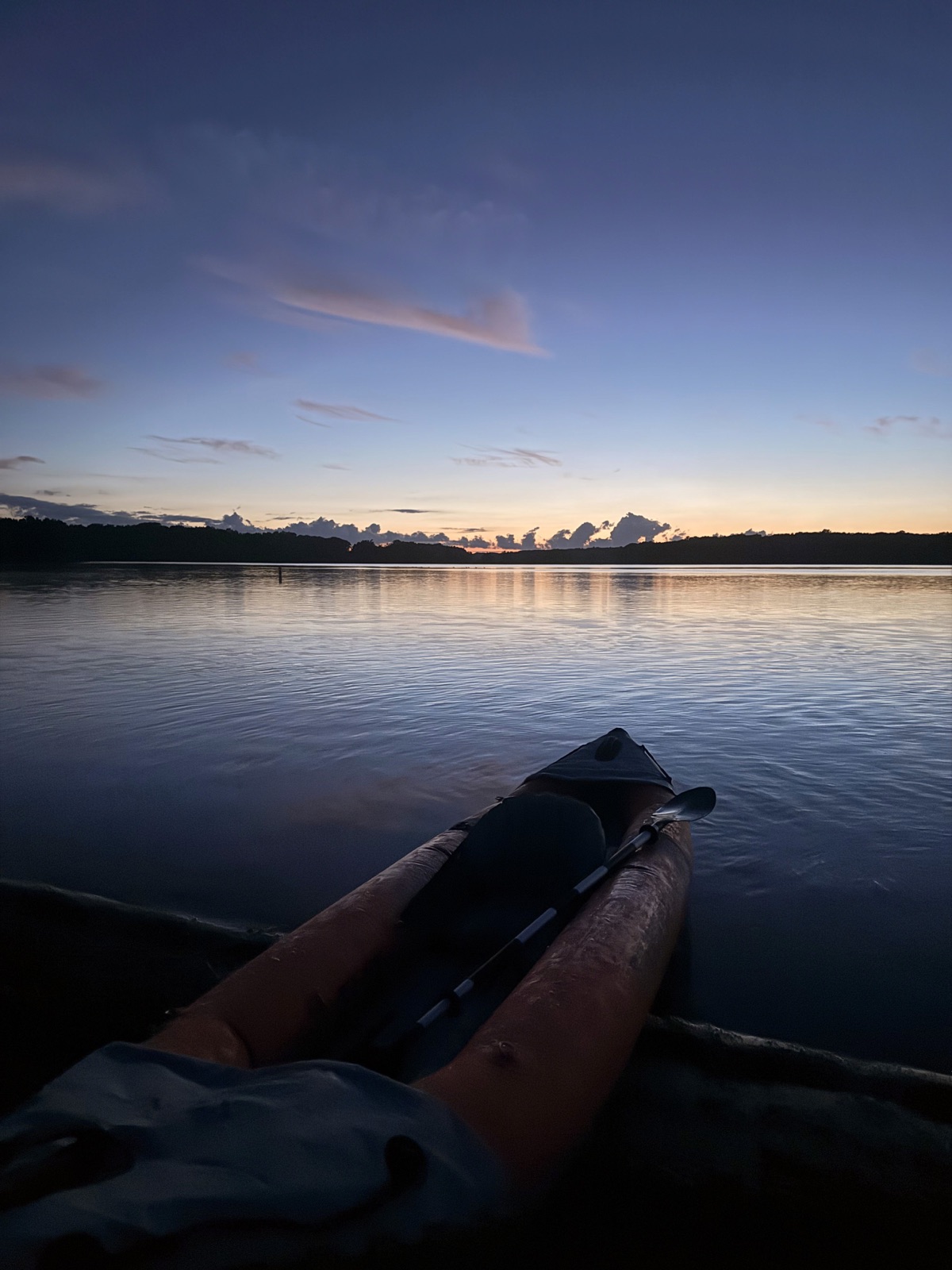 A kayak on calm water at dusk