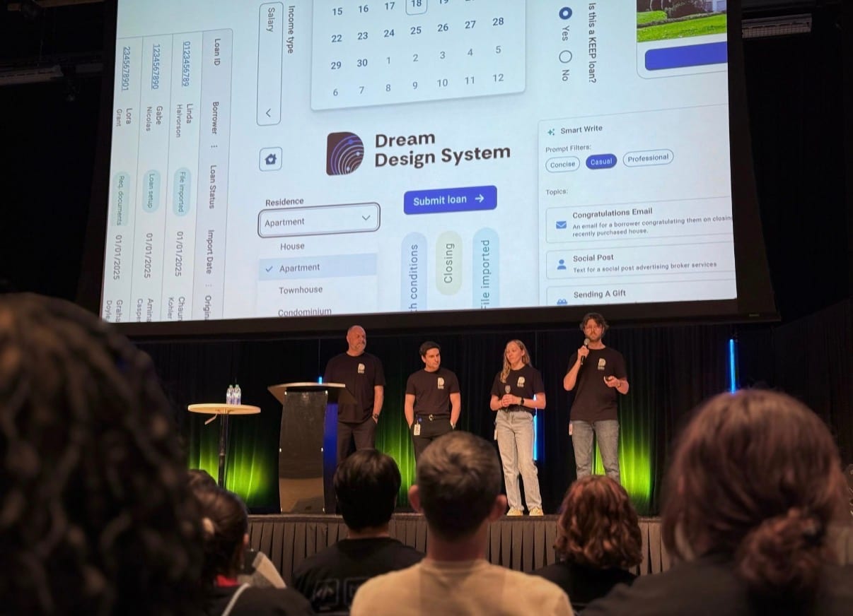 The Dream team presenting on stage beneath a large screen showing Dream Design System components